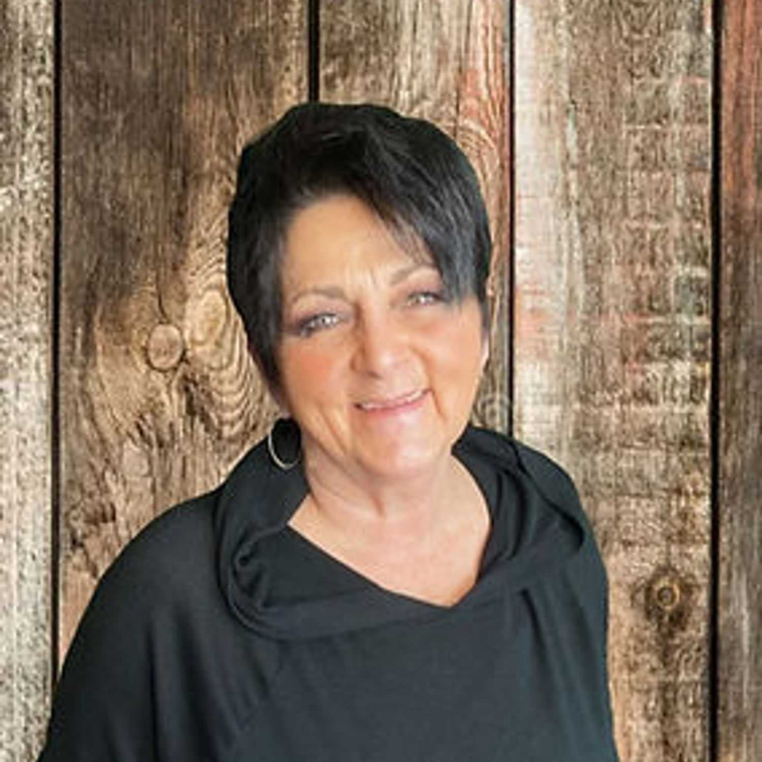 Portrait of Kathy, a professional stylist at O Salon, showcasing their expertise and style.