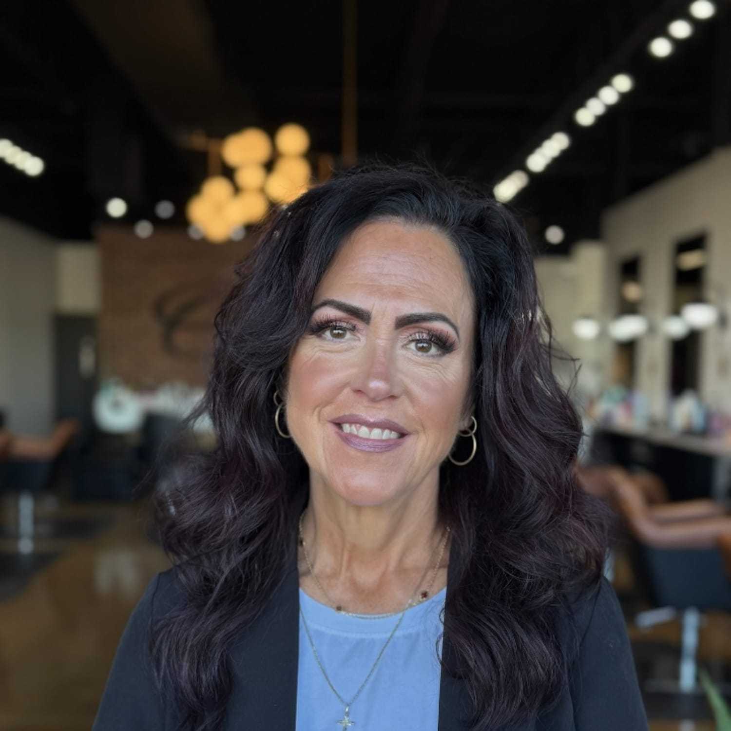 Portrait of Terri Mayer, a professional stylist at O Salon, showcasing their expertise and style.